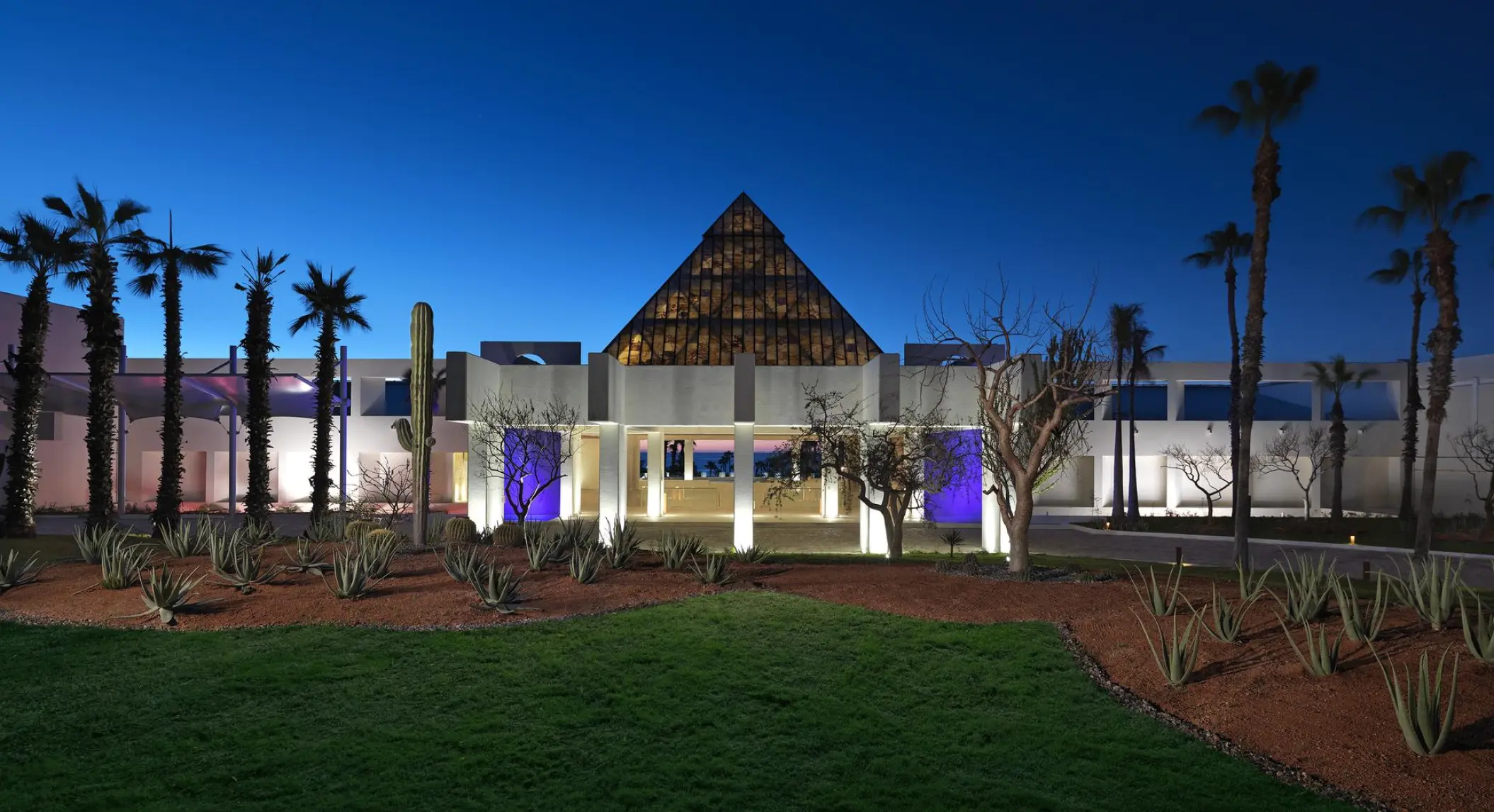 Pyramid-shaped main entrance and illuminated grounds of Paradisus Los Cabos at night, Cabo San Lucas
