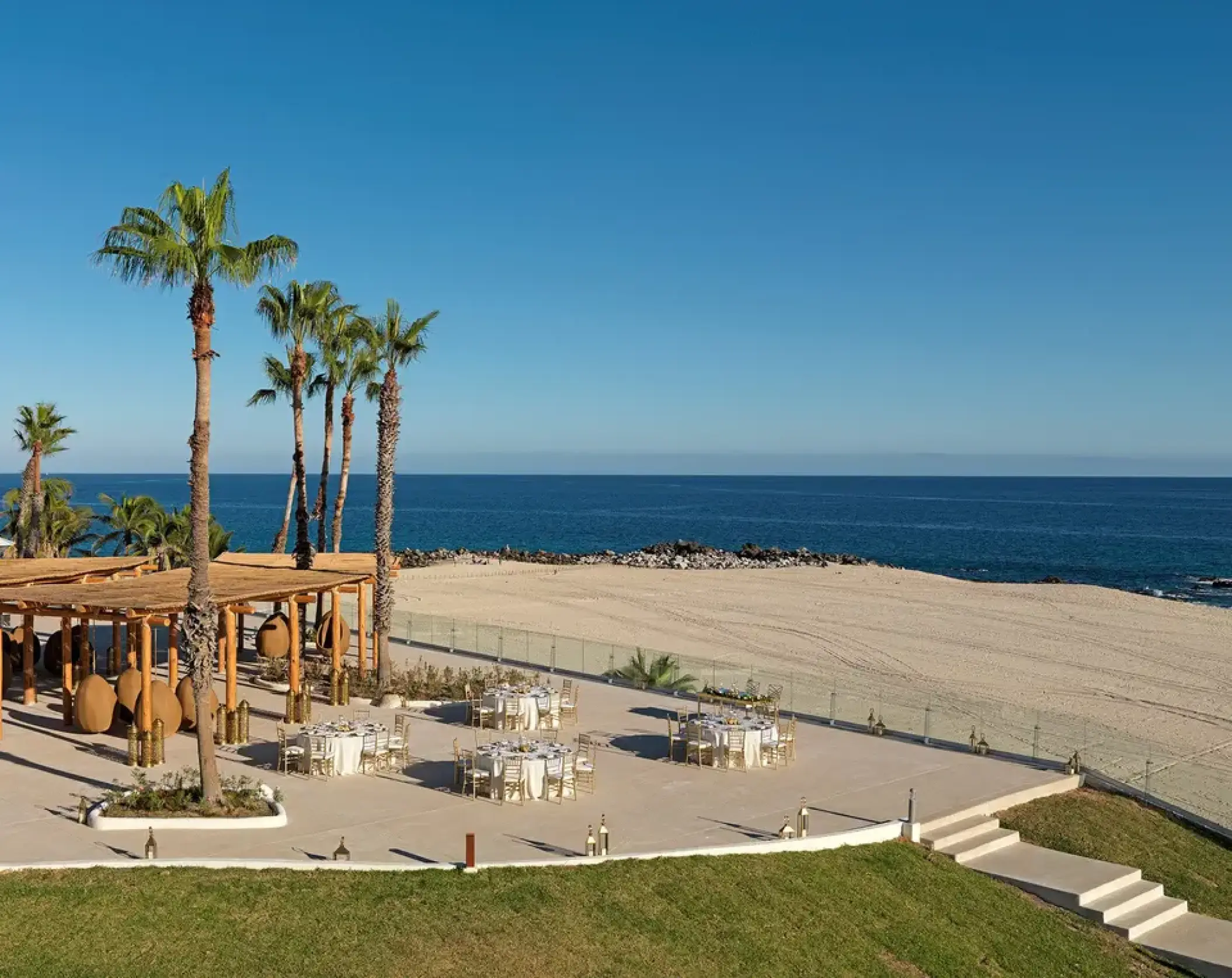 Outdoor wedding reception setup on the ocean terrace at Paradisus Los Cabos, Cabo San Lucas