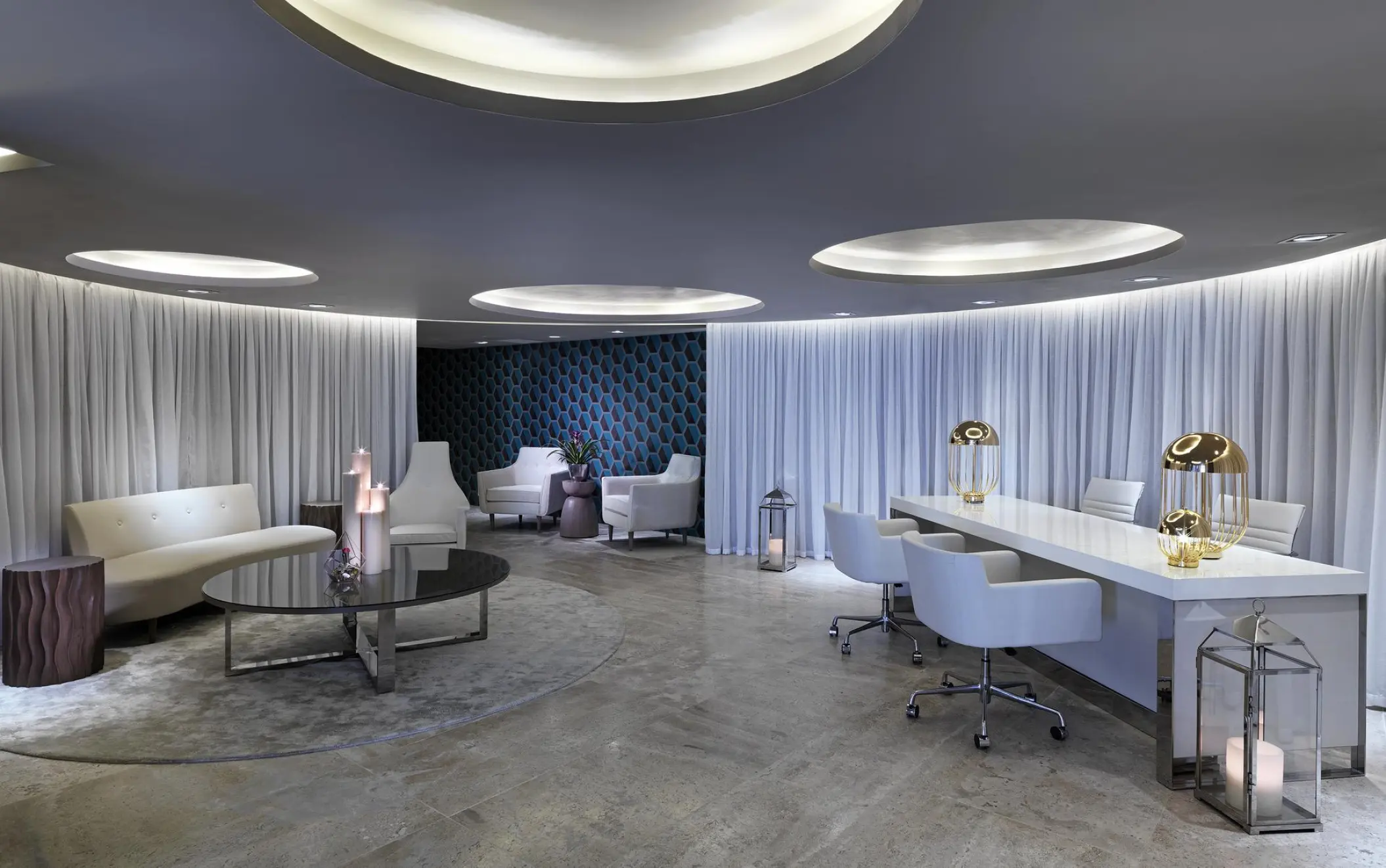 Modern spa reception area with white furniture and circular ceiling lights at Paradisus Los Cabos, Cabo San Lucas