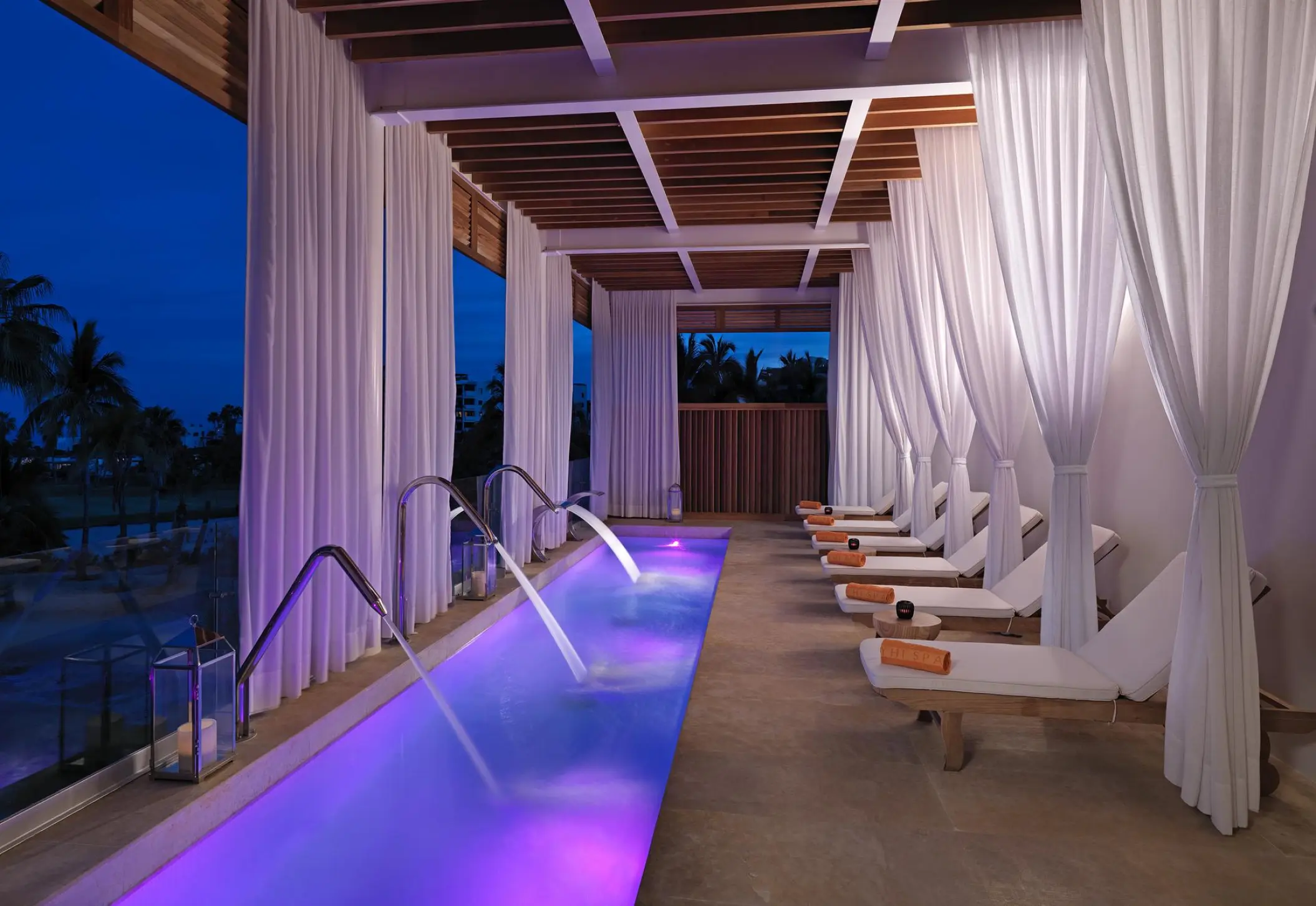 Spa hydrotherapy pool with swan neck fountains and lounge chairs at Paradisus Los Cabos, Cabo San Lucas