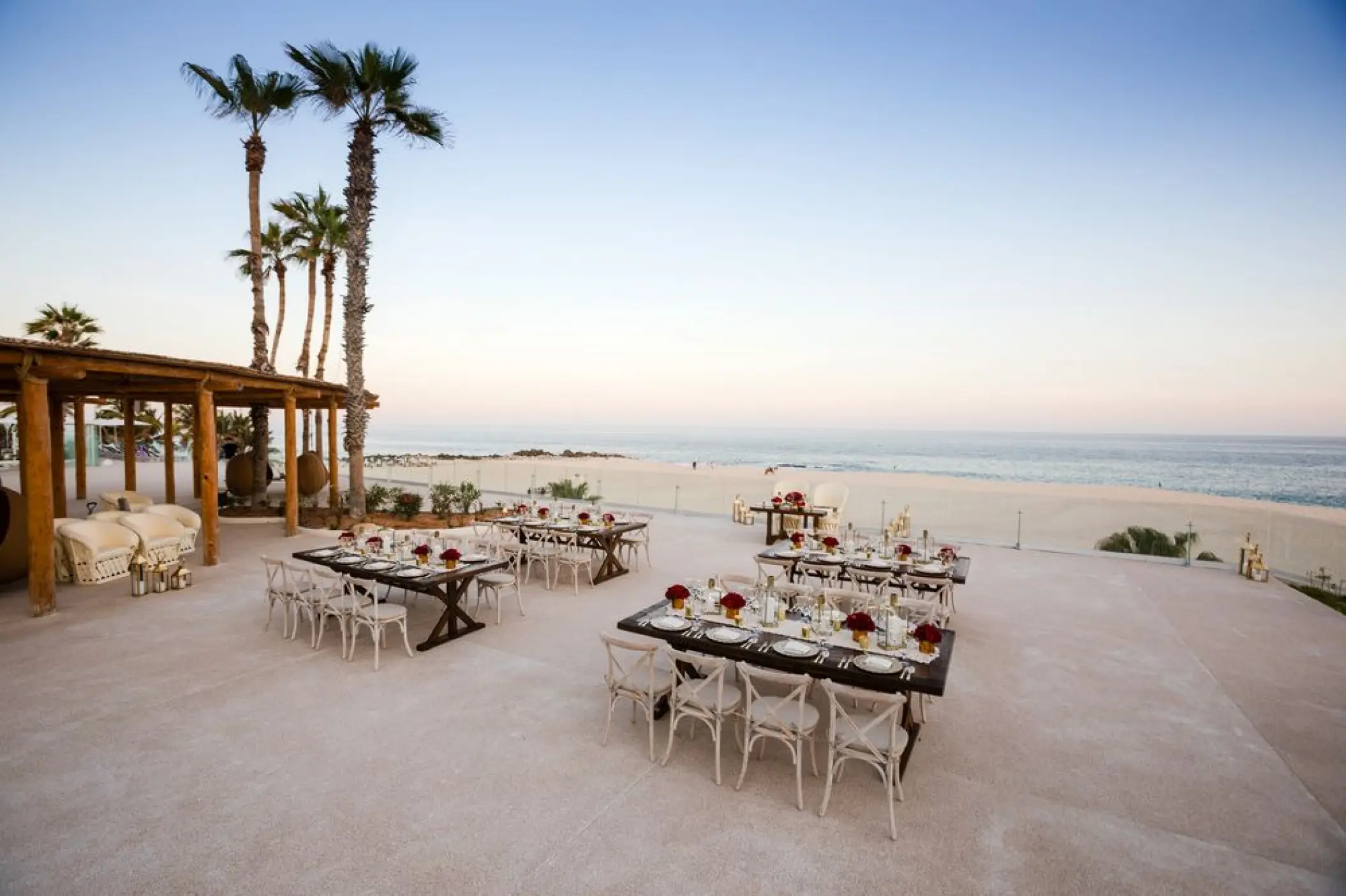 Outdoor wedding reception setup on a terrace overlooking the beach at Paradisus Los Cabos, Cabo San Lucas