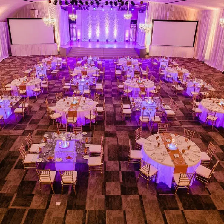 Indoor wedding reception with purple lighting in the ballroom at Paradisus La Perla, Playa Del Carmen
