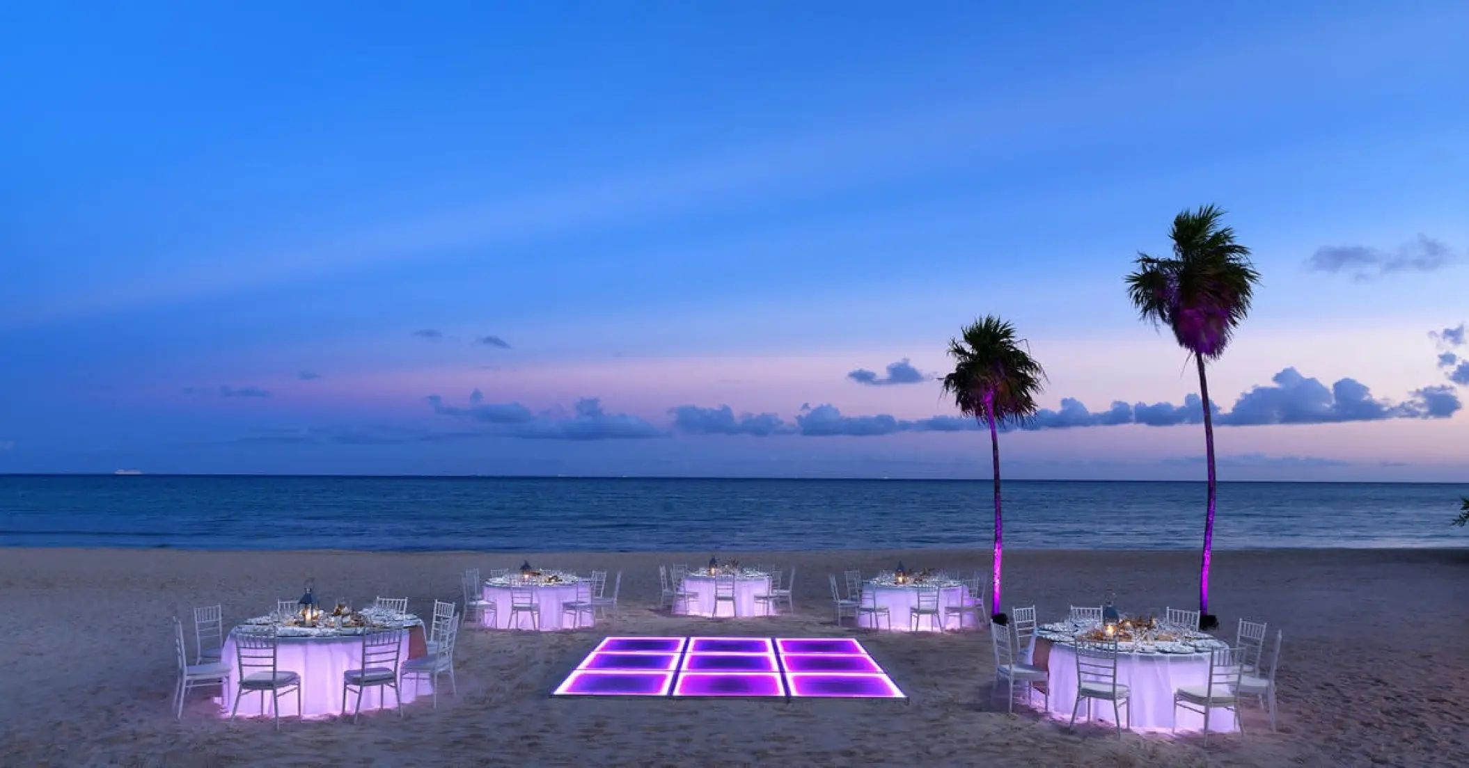 Beach wedding reception with glowing dance floor at Paradisus La Perla, Playa Del Carmen