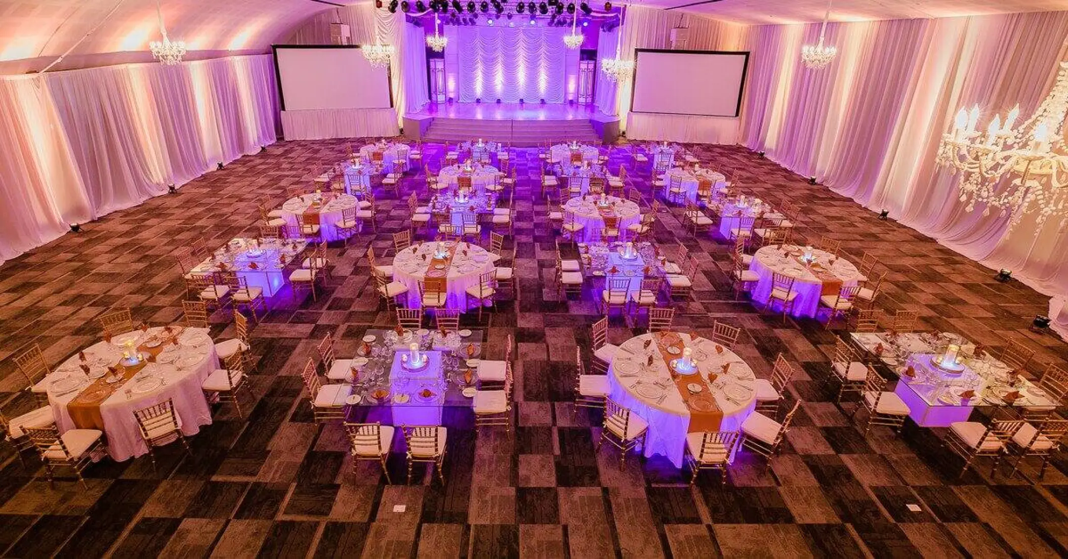 Indoor wedding reception with purple lighting in the ballroom at Paradisus Playa Del Carmen