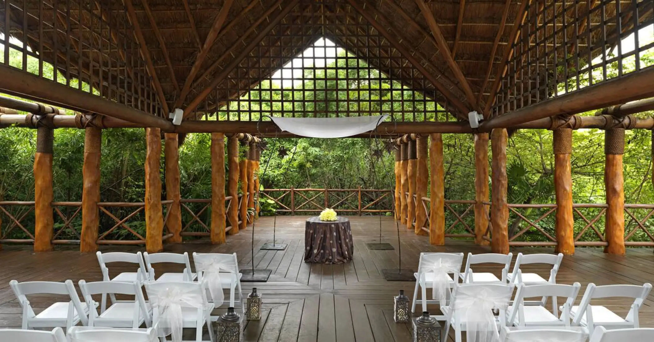 Jungle-themed wedding ceremony venue under a thatched roof at Paradisus Playa Del Carmen