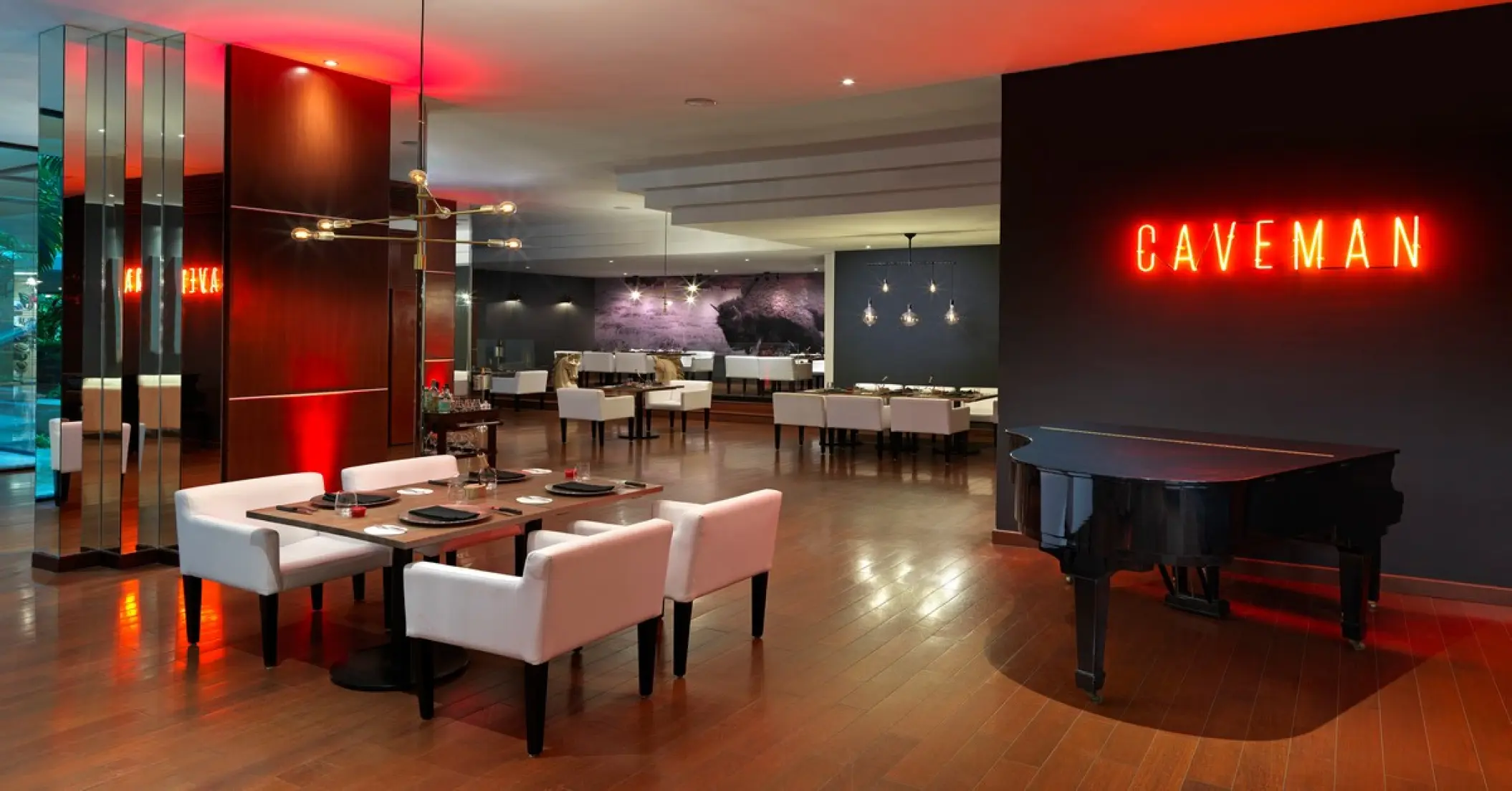 SAL Steak & Cave restaurant with a grand piano and neon sign at Paradisus Cancun