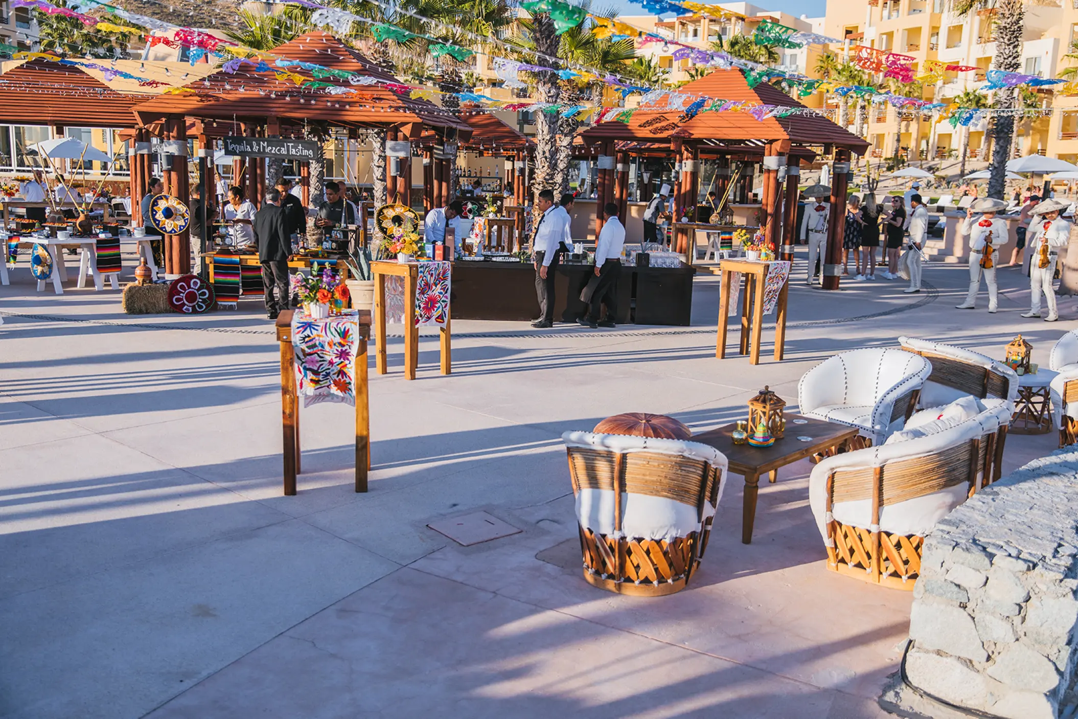 Aire Terrace wedding reception with colorful banners and lounge seating at Pueblo Bonito Pacifica, Cabo San Lucas