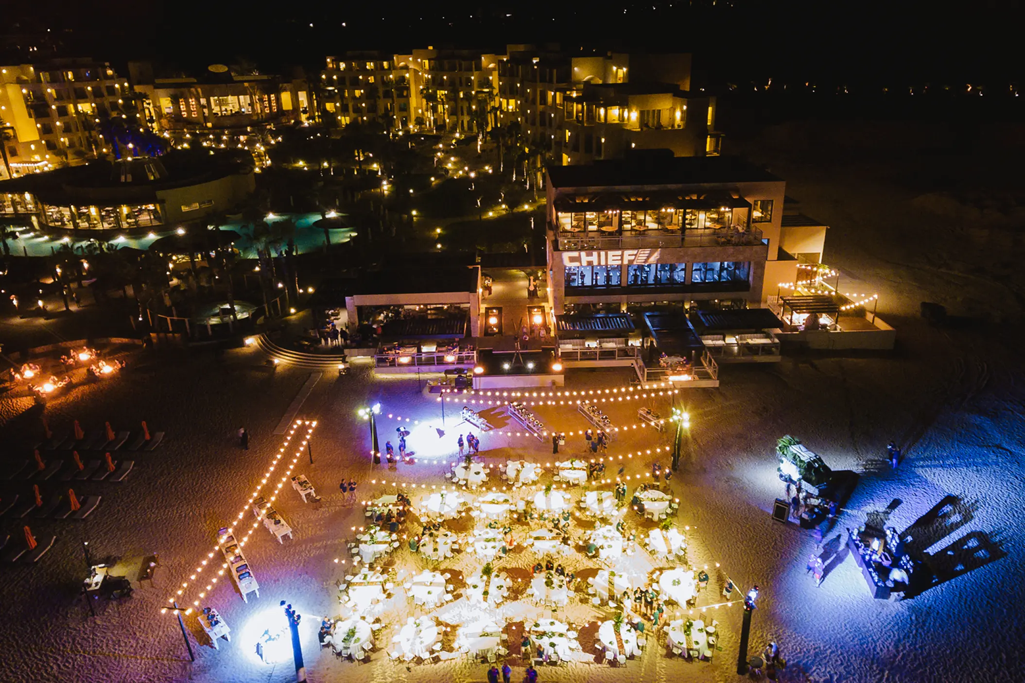 Nighttime beach wedding reception with string lights at Pueblo Bonito Pacifica, Cabo San Lucas