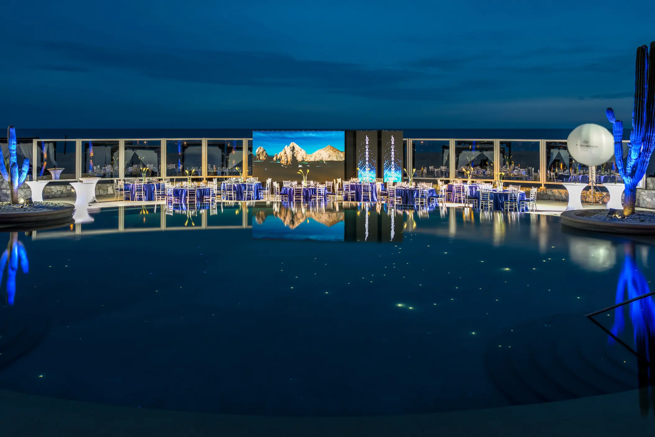 Constellation Pool terrace wedding reception with blue lighting at Pueblo Bonito Pacifica, Cabo San Lucas