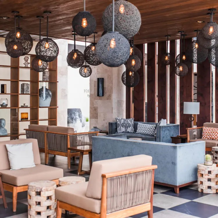 Modern lounge area with wicker orb pendant lights at Pueblo Bonito Pacifica, Cabo San Lucas