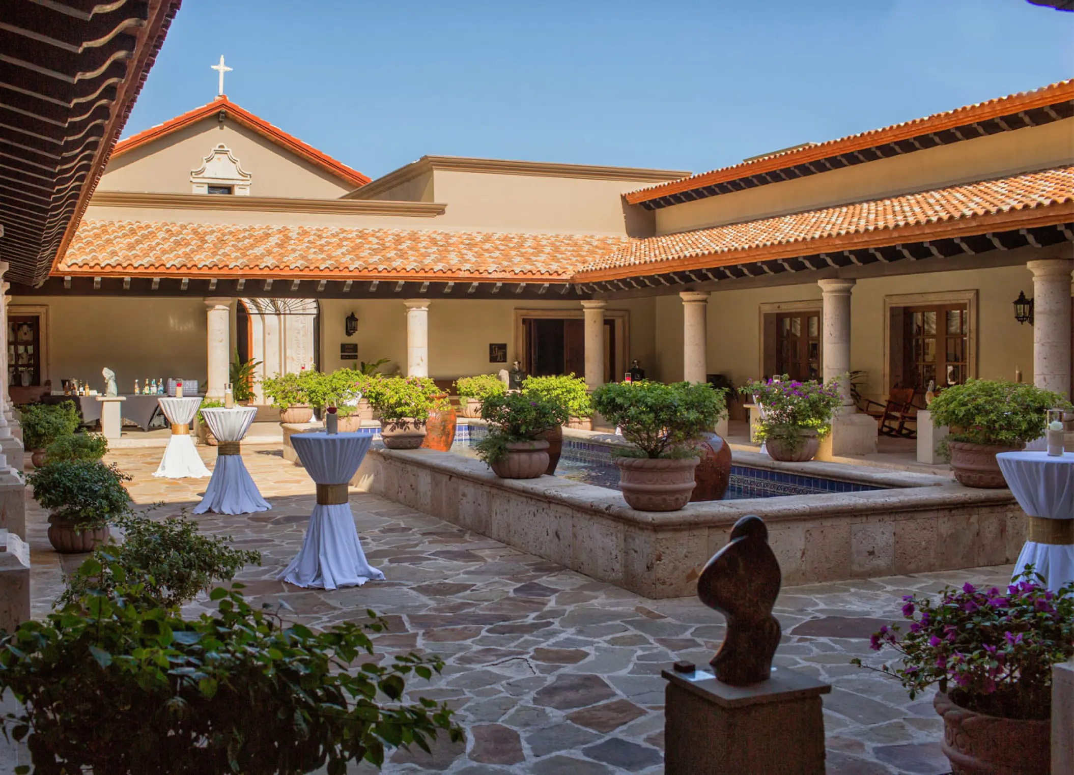 Cocktail reception courtyard with stone fountain and cocktail tables at Pueblo Bonito Sunset Beach, Cabo San Lucas