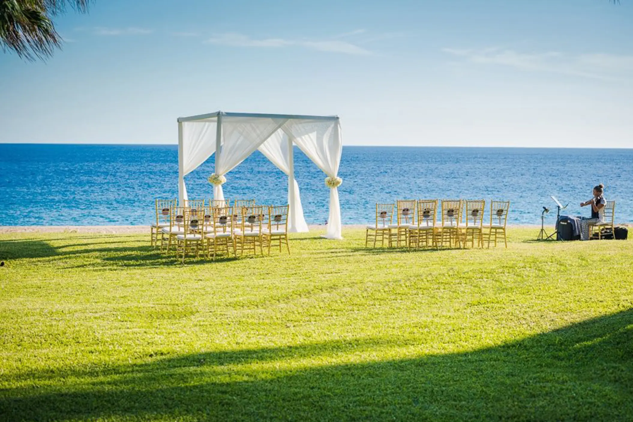 Oceanfront wedding ceremony setup on Lovers Meadow at Pueblo Bonito Sunset Beach, Cabo San Lucas