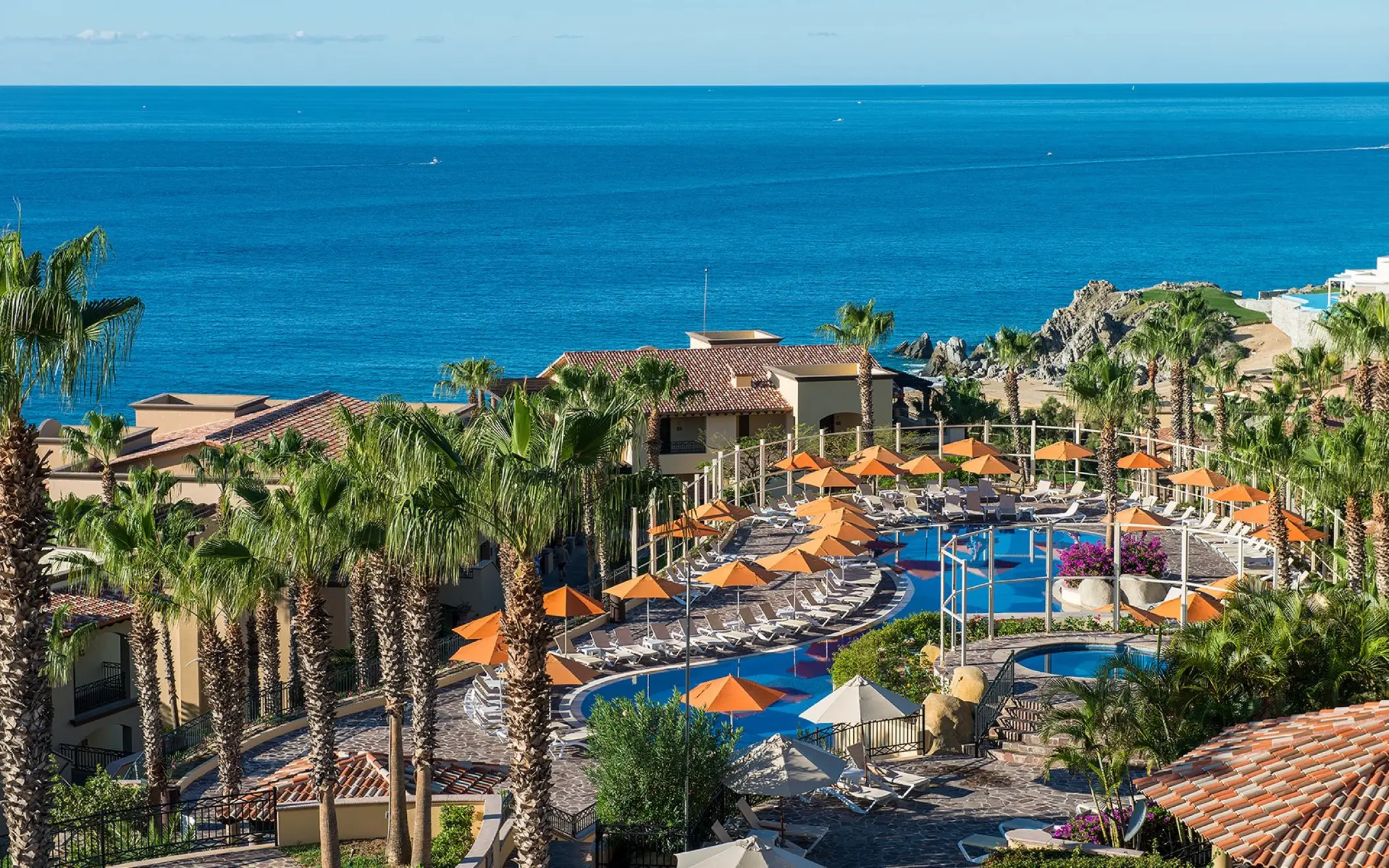 Pueblo Bonito Sunset Beach main pool and sun loungers overlooking the ocean, Cabo San Lucas