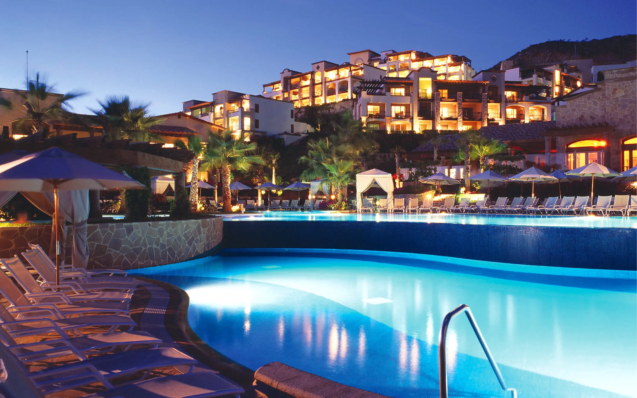 Illuminated tiered infinity pools at Pueblo Bonito Sunset Beach, Cabo San Lucas