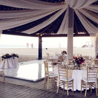 Draped wedding reception setup on the Ocean Breeze Deck at Pueblo Bonito Sunset Beach, Cabo San Lucas