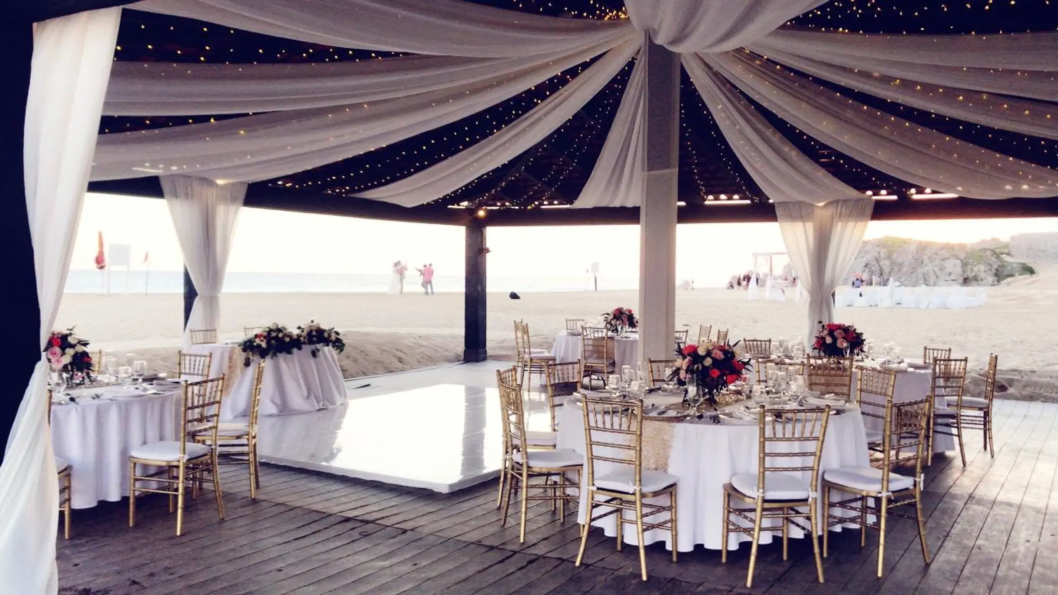 Draped wedding reception setup on the Ocean Breeze Deck at Pueblo Bonito Sunset Beach, Cabo San Lucas