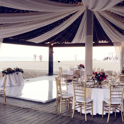 Draped wedding reception setup on the Ocean Breeze Deck at Pueblo Bonito Sunset Beach, Cabo San Lucas