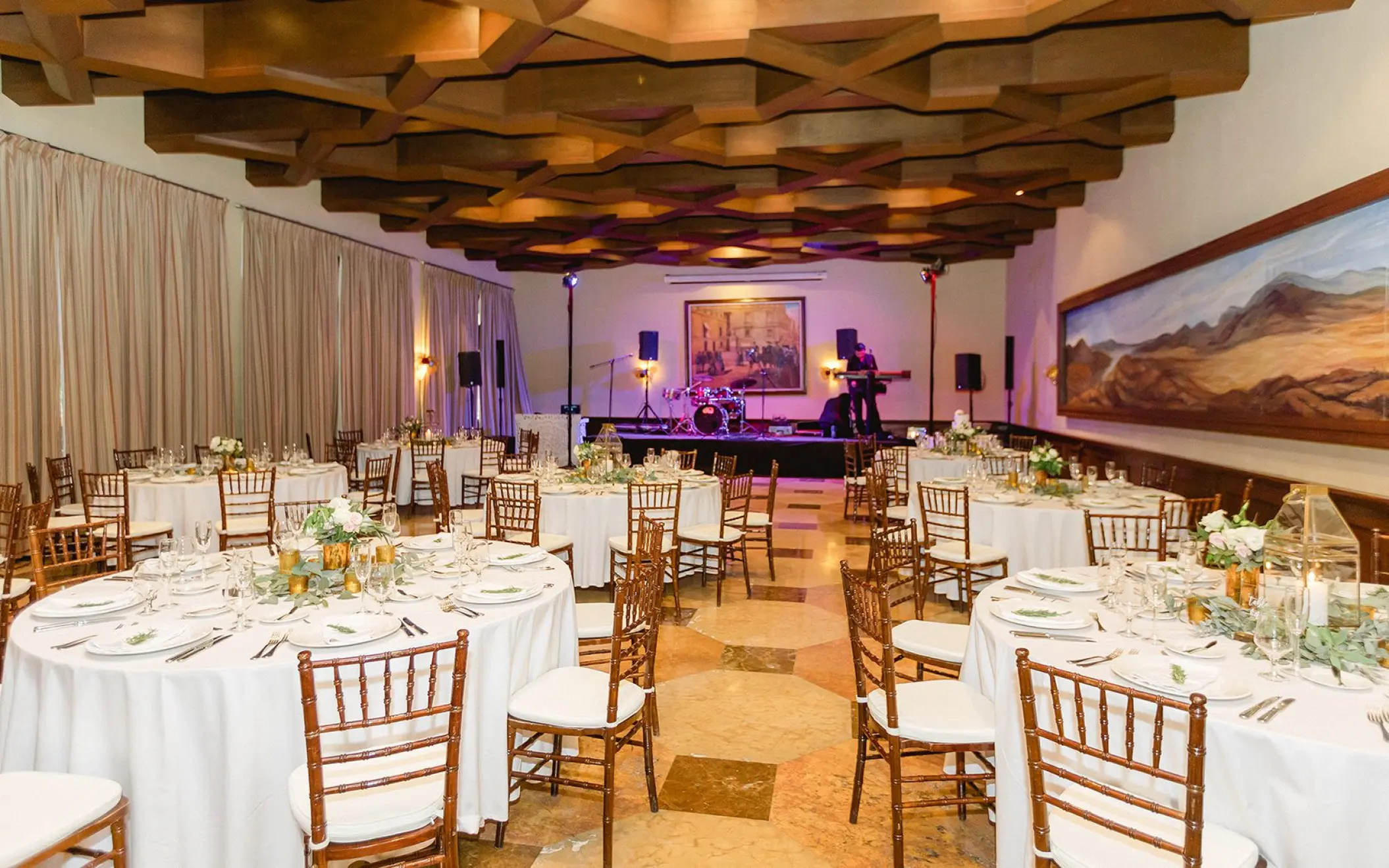 Santa Ana Ballroom wedding reception with round tables and a live band stage at Pueblo Bonito Sunset Beach, Cabo San Lucas