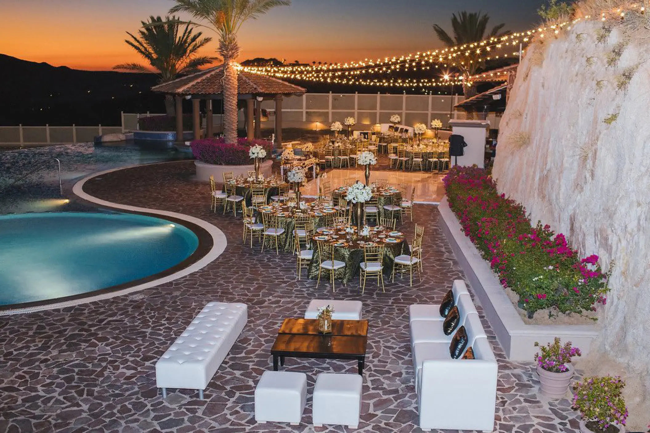 Sky Pool terrace wedding reception with string lights at Pueblo Bonito Sunset Beach, Cabo San Lucas