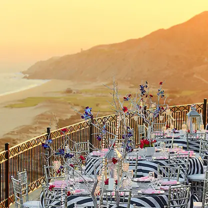 Terrace wedding reception with striped linens at Pueblo Bonito Sunset Beach, Cabo San Lucas
