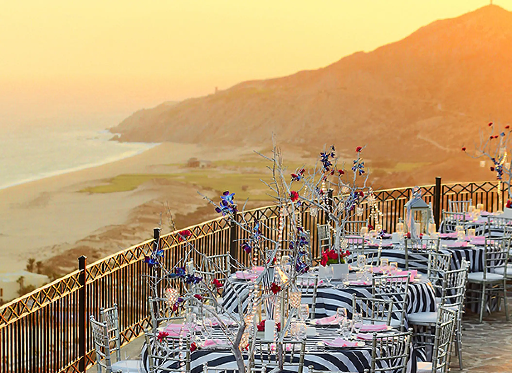 Terrace wedding reception with striped linens at Pueblo Bonito Sunset Beach, Cabo San Lucas
