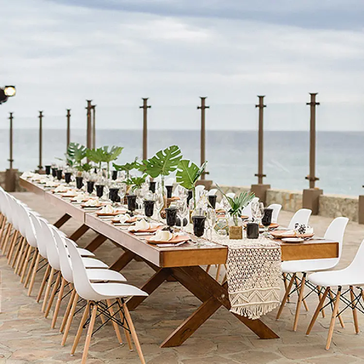 Outdoor wedding reception table with ocean views at Pueblo Bonito Sunset Beach, Cabo San Lucas