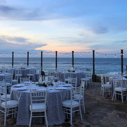 Oceanfront wedding reception with blue patterned tablecloths at Pueblo Bonito Sunset Beach, Cabo San Lucas