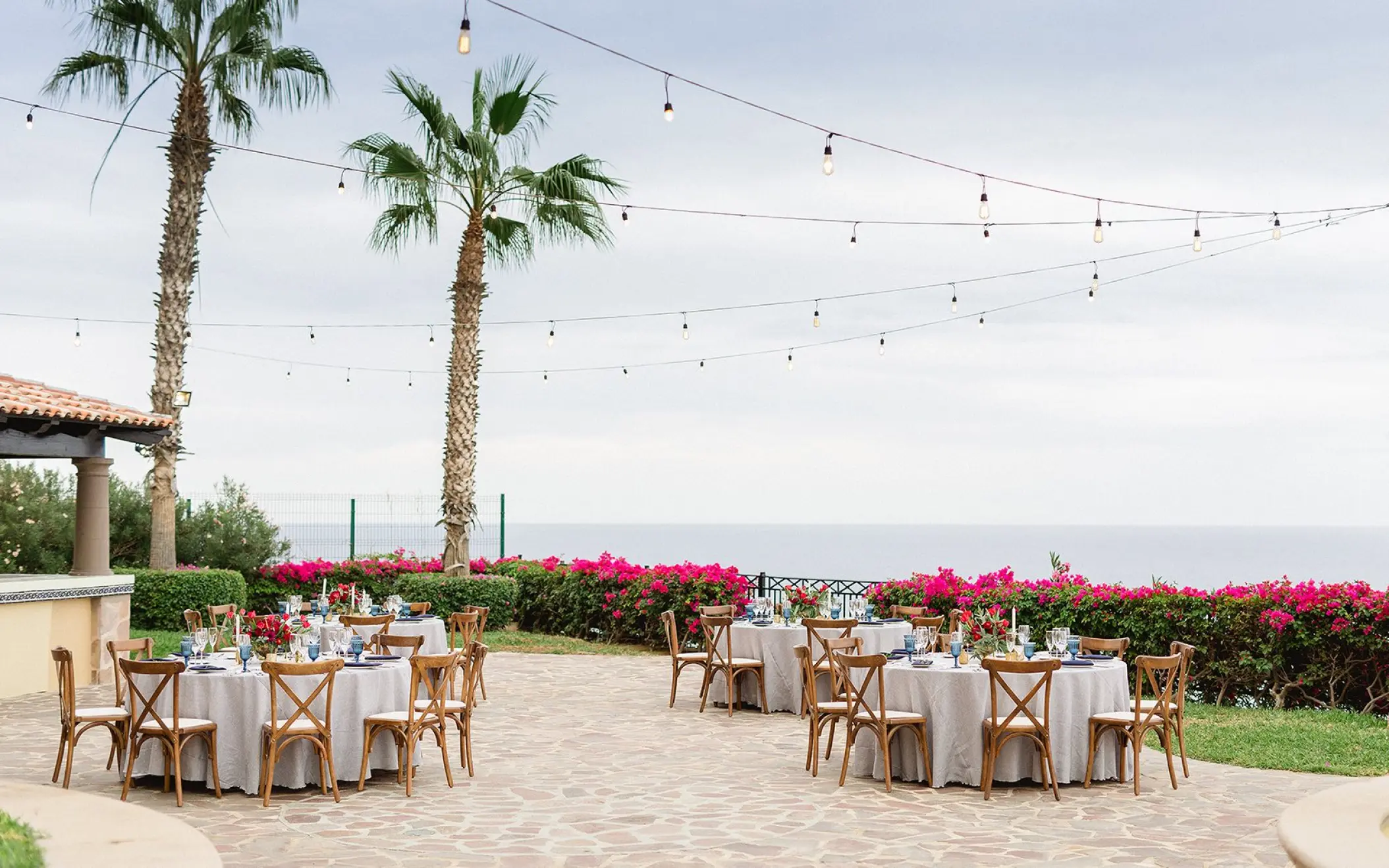 Outdoor wedding reception setup with string lights on Swan Terrace at Pueblo Bonito Sunset Beach, Cabo San Lucas