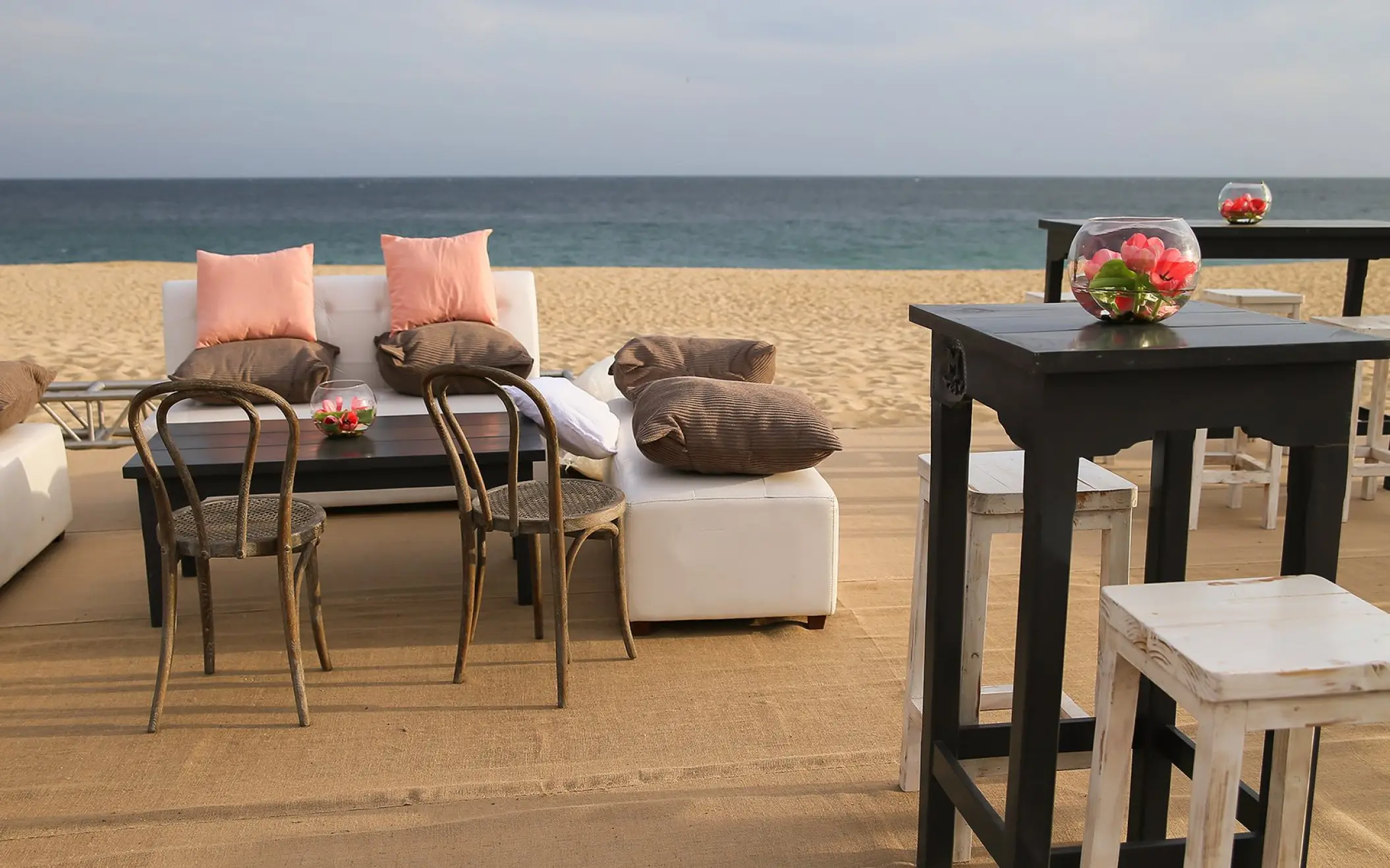 Beachfront wedding reception lounge with white sofas and high-top tables at Pueblo Bonito Sunset Beach, Cabo San Lucas