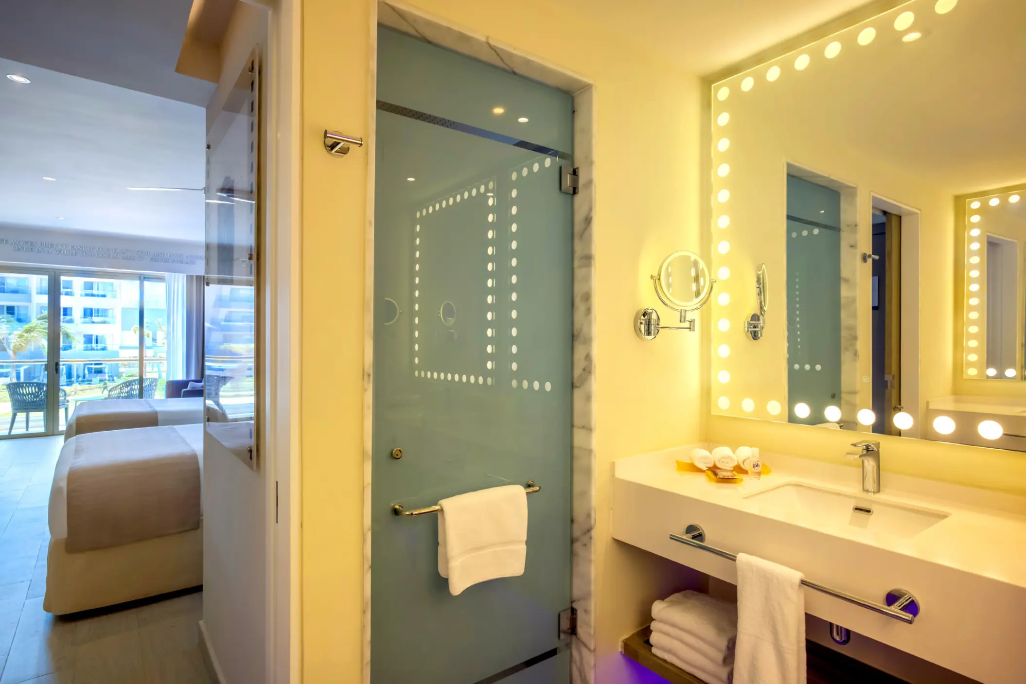 Modern bathroom suite with Hollywood-style vanity lighting at Planet Hollywood Adult Scene, Cancun