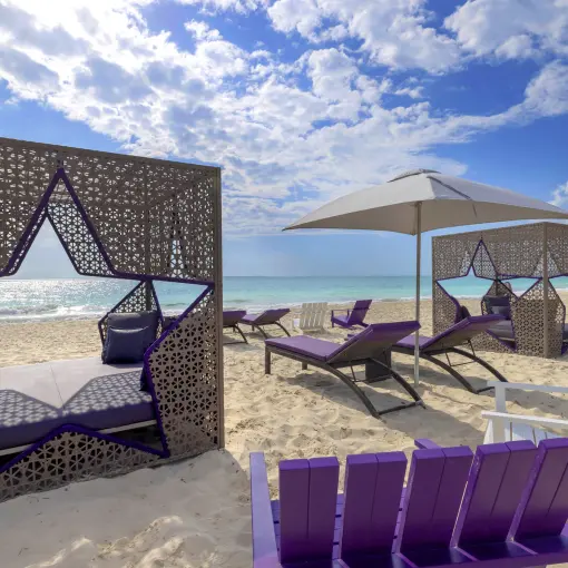Star-shaped beach cabanas and purple lounge chairs at Planet Hollywood Cancun