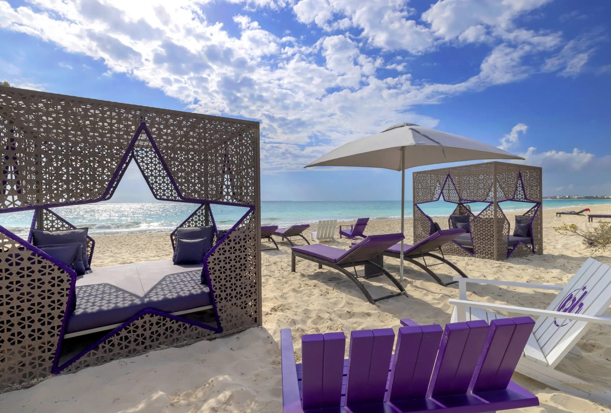Star-shaped beach cabanas and purple lounge chairs at Planet Hollywood Cancun