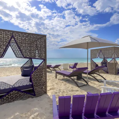 Star-shaped beach cabanas and purple lounge chairs at Planet Hollywood Cancun