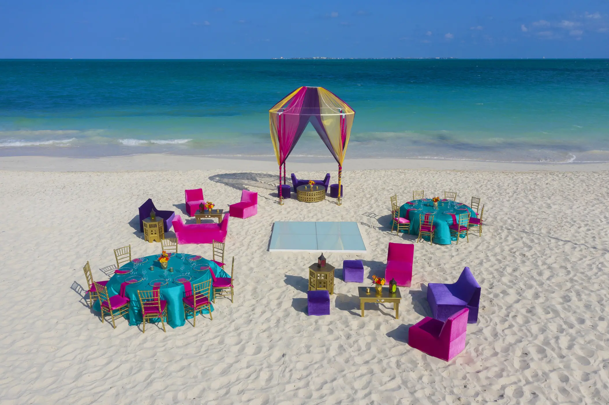 Colorful beachfront wedding reception setup at Planet Hollywood Cancun