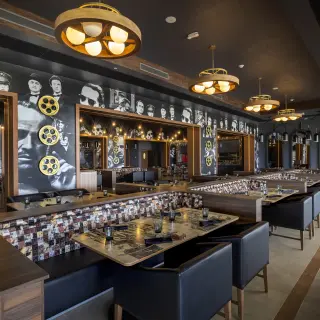 Movie-themed dining room with black and white celebrity murals at Planet Hollywood Cancun