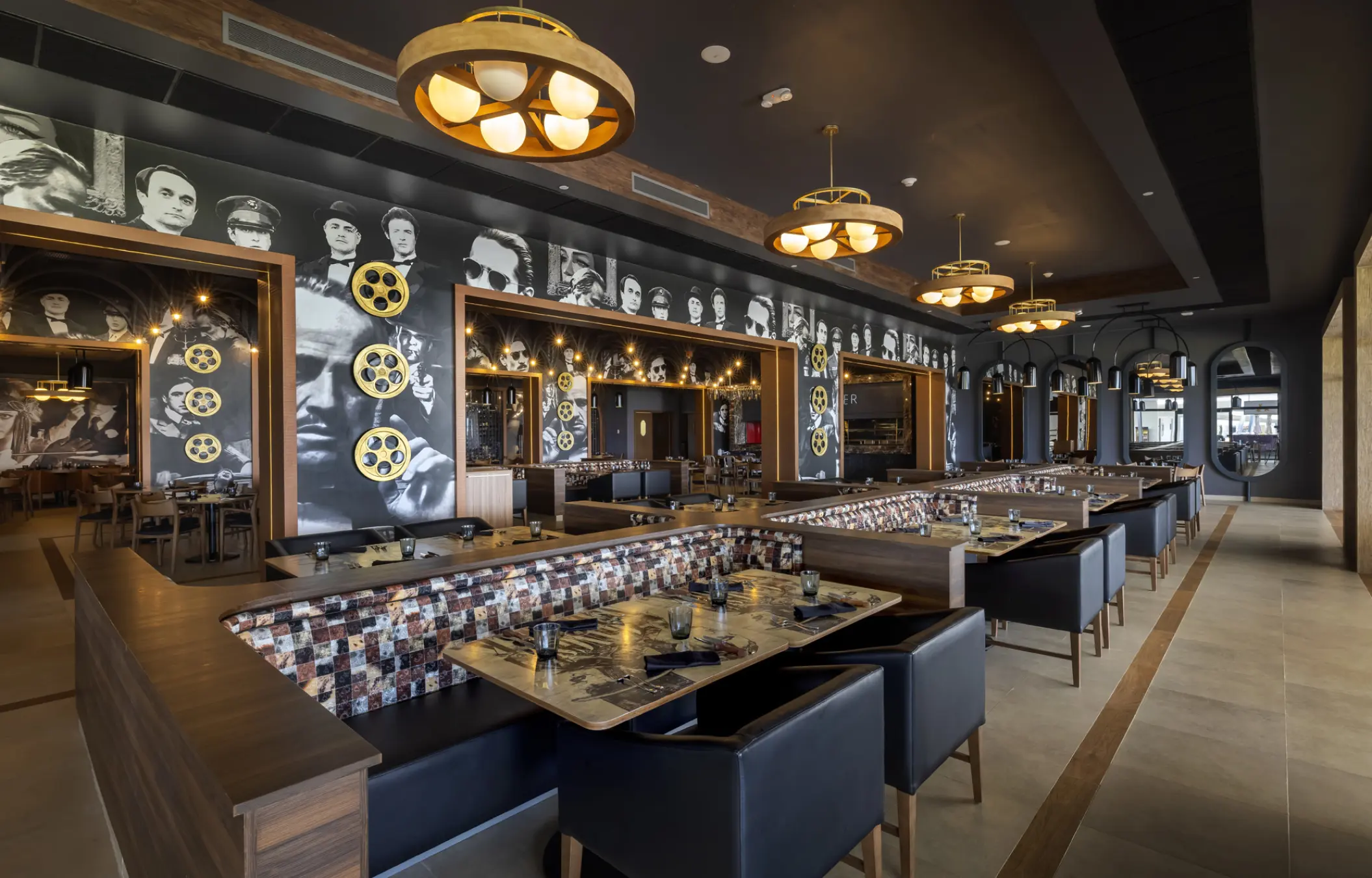 Movie-themed dining room with black and white celebrity murals at Planet Hollywood Cancun