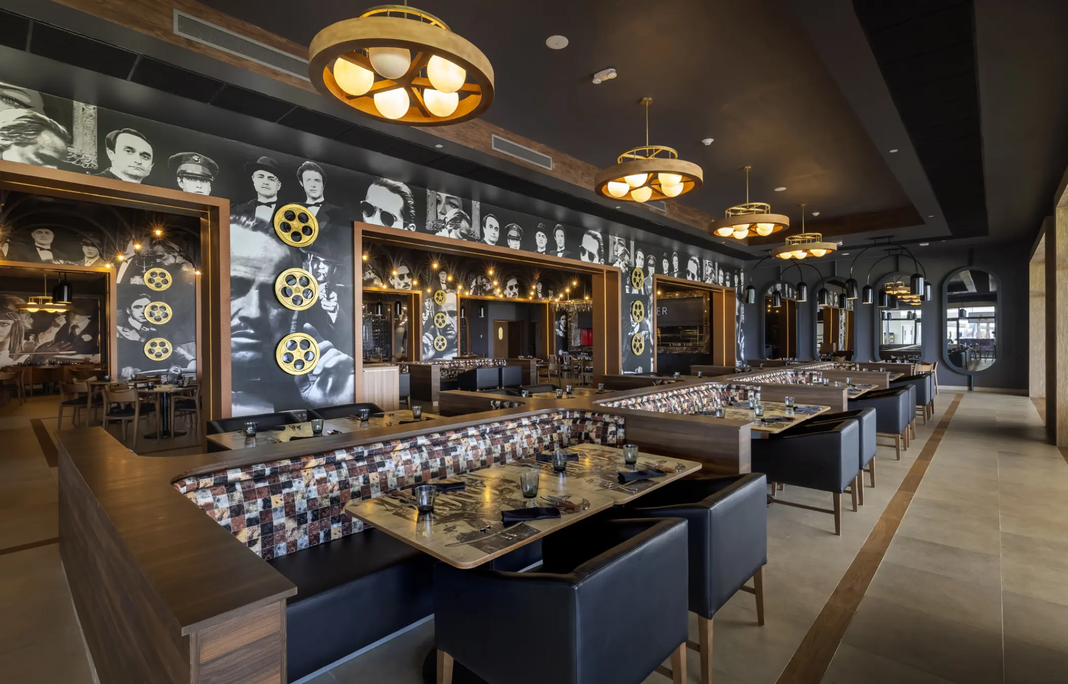 Movie-themed dining room with black and white celebrity murals at Planet Hollywood Cancun