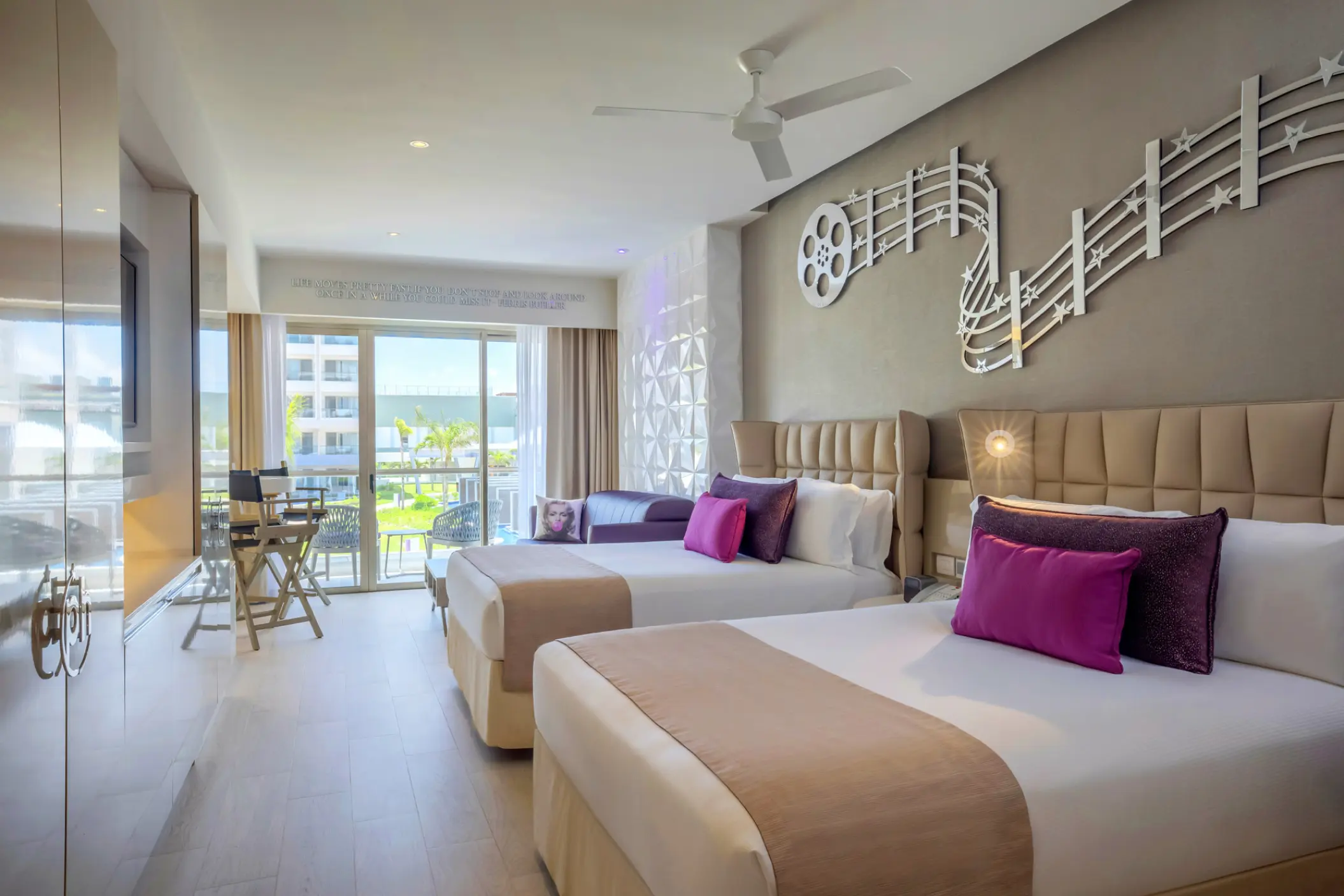 Modern guest room with two double beds and film-themed decor at Planet Hollywood Cancun