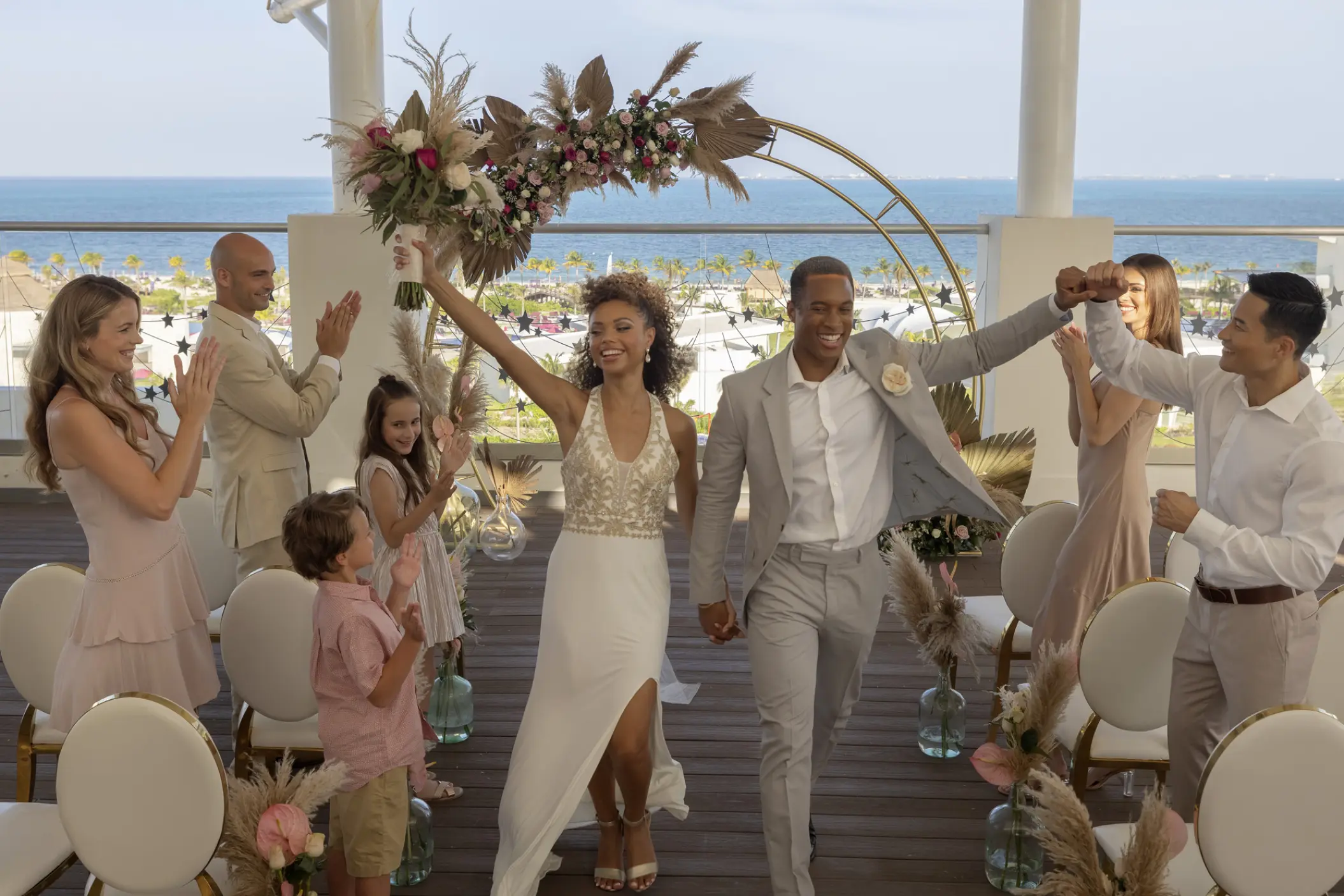 Newlywed couple celebrating at a rooftop wedding ceremony at Planet Hollywood Cancun