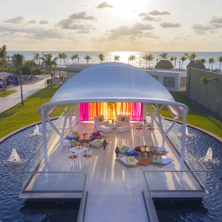 White gazebo lounge with colorful decor at Planet Hollywood Cancun