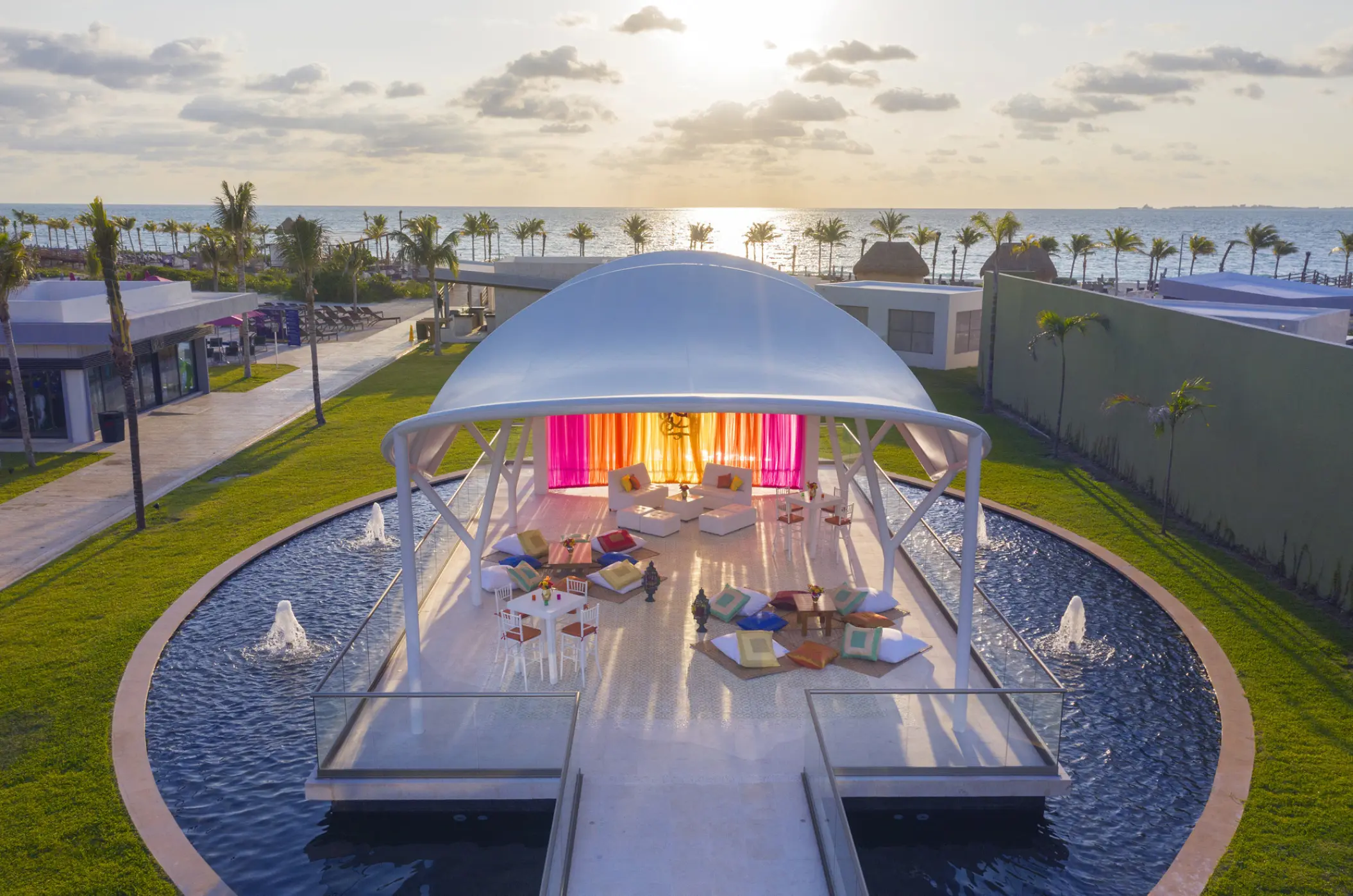 White gazebo lounge with colorful decor at Planet Hollywood Cancun