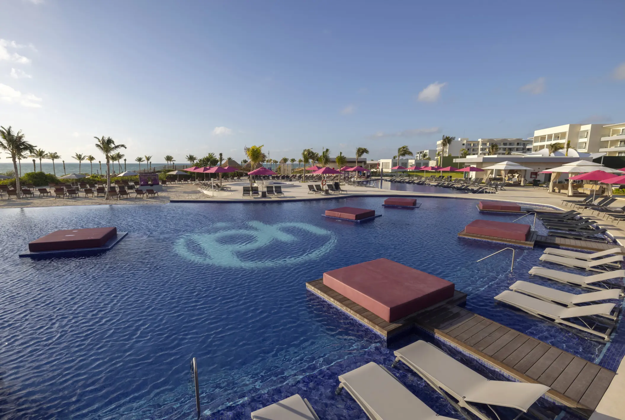 Planet Hollywood Cancun adult pool with floating daybeds and logo, Cancun