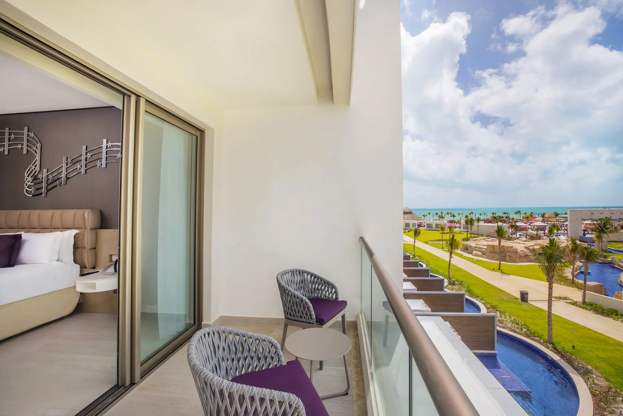 Planet Hollywood Cancun suite terrace with view of swim-up pools and tropical grounds, Cancun