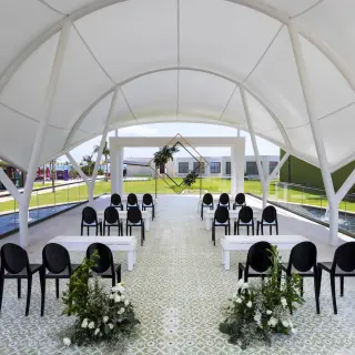 Modern outdoor wedding ceremony venue under a white canopy at Planet Hollywood Adult Scene, Cancun