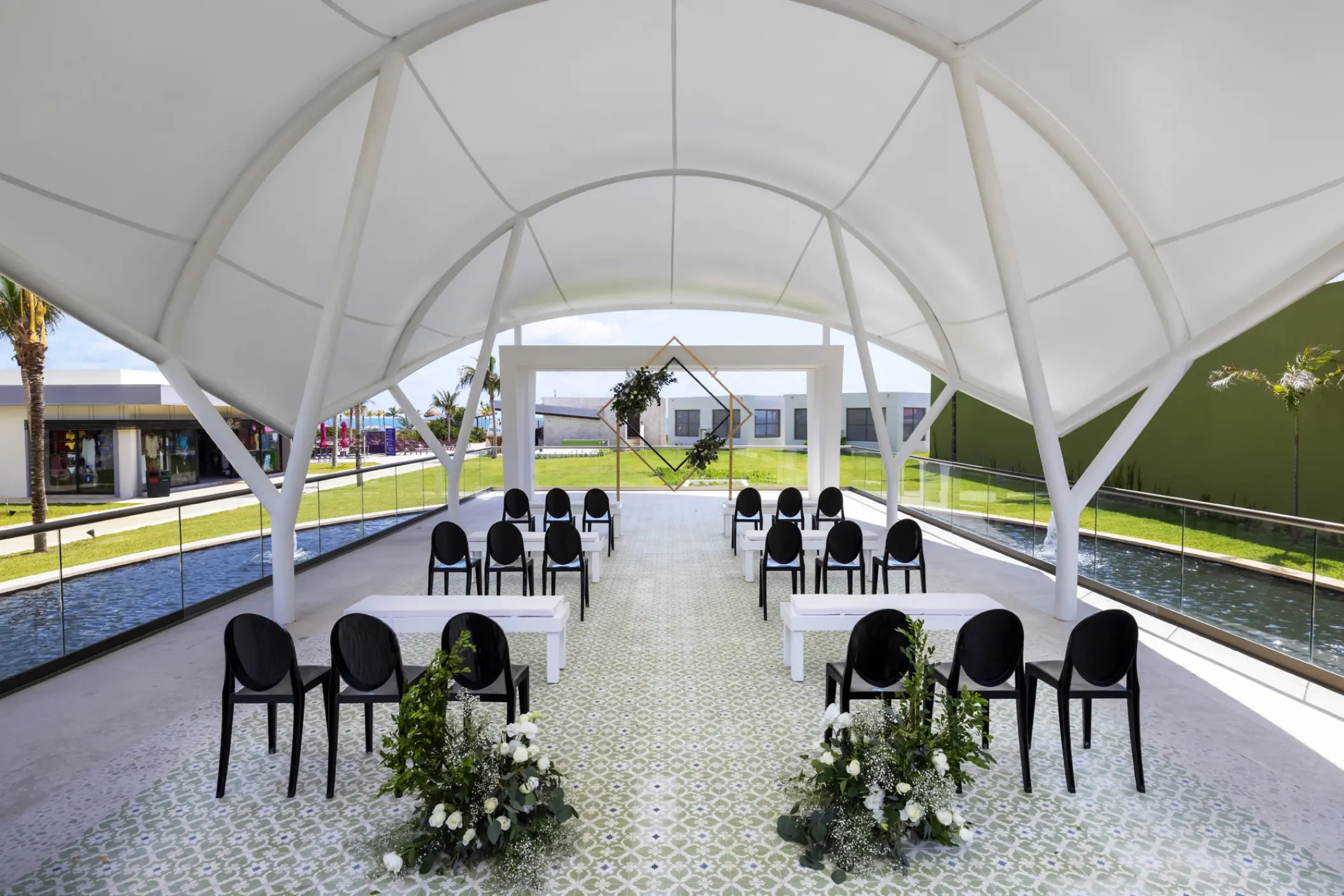 Modern outdoor wedding ceremony venue under a white canopy at Planet Hollywood Adult Scene, Cancun
