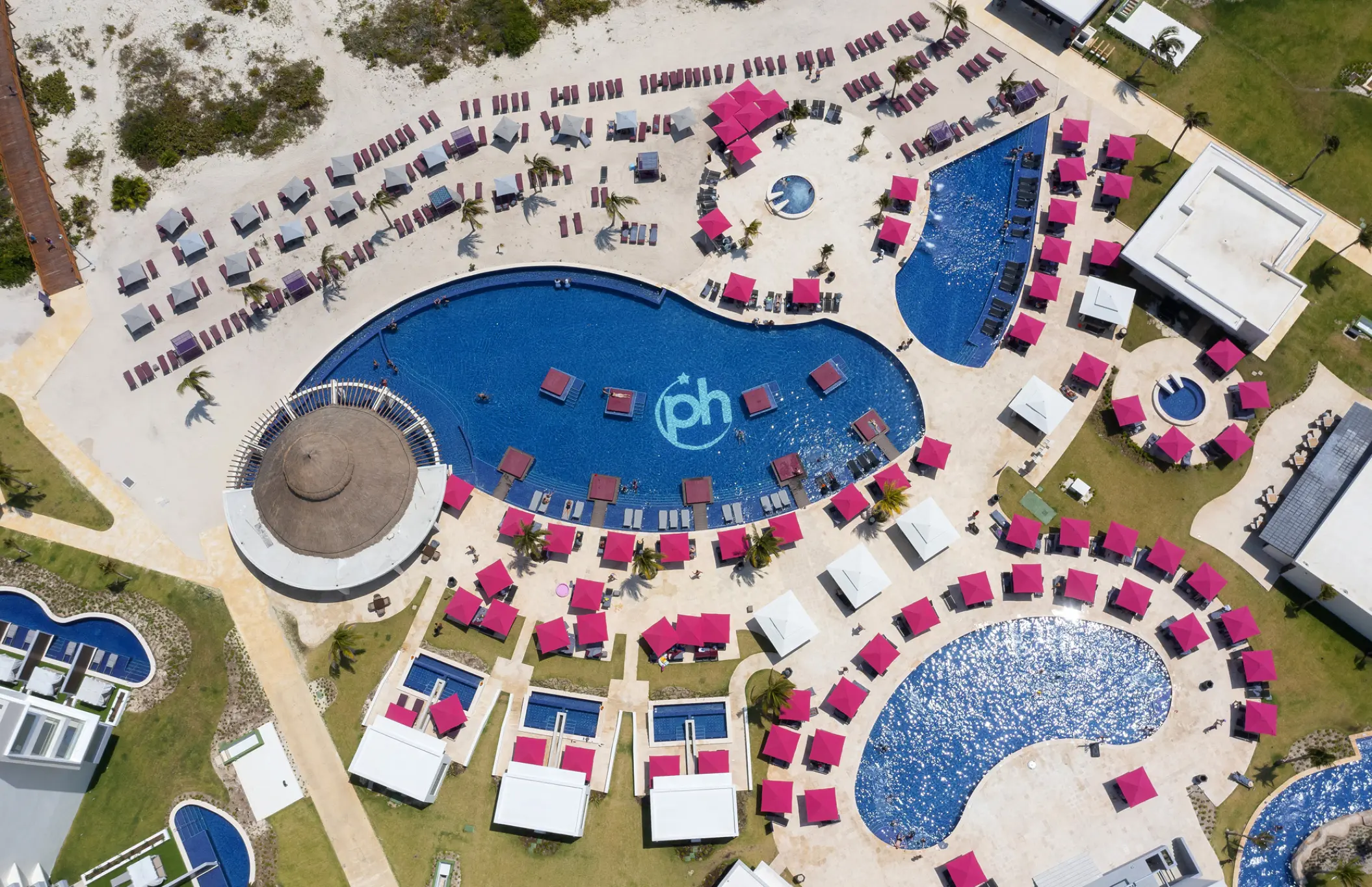 Aerial view of swimming pools and pink umbrellas at Planet Hollywood Cancun