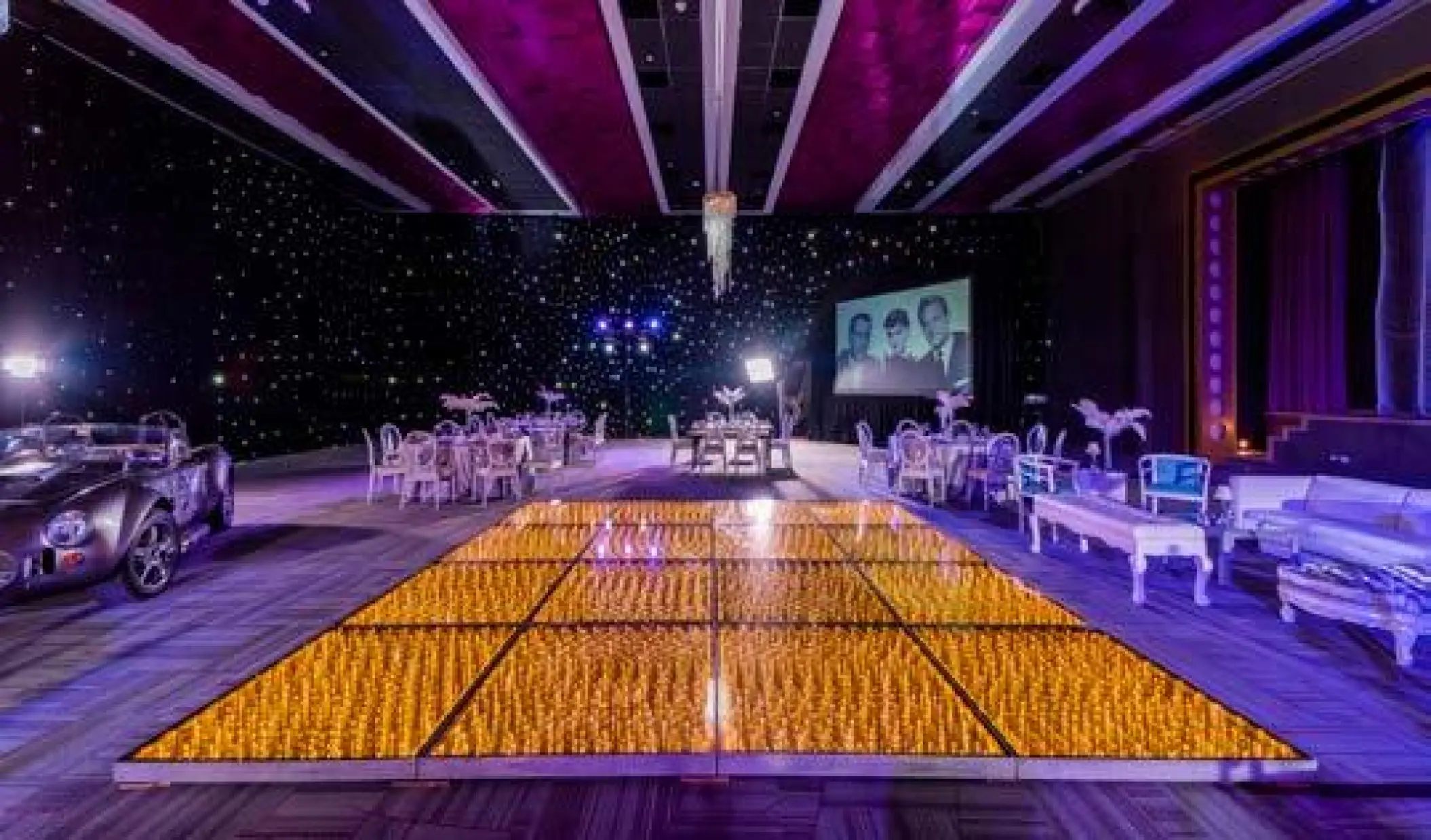 Blockbuster Ballroom wedding reception setup with lit dance floor at Planet Hollywood Cancun