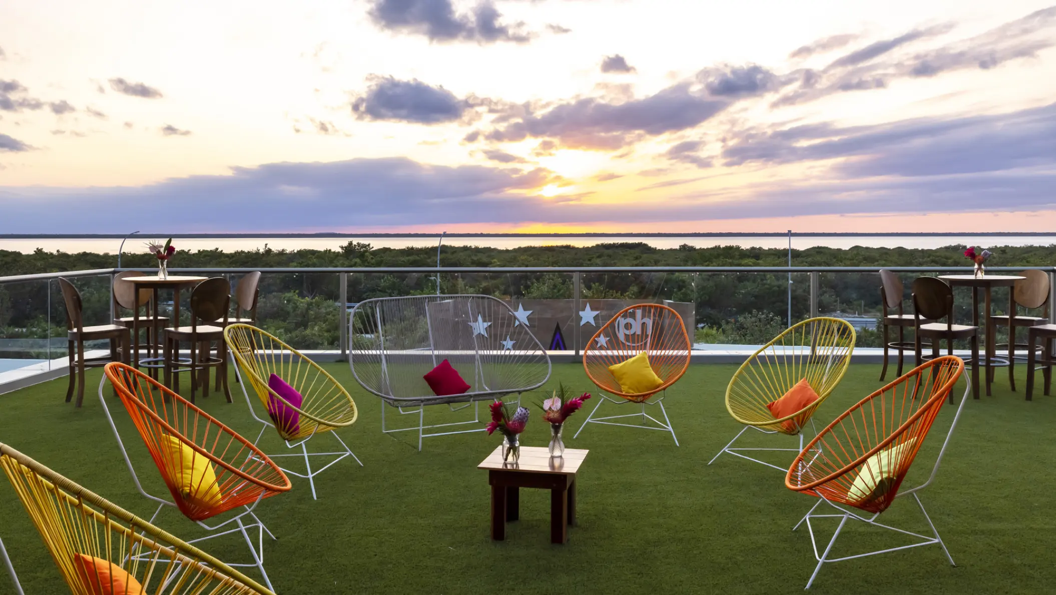 Rooftop wedding cocktail terrace with colorful Acapulco chairs at Planet Hollywood Cancun