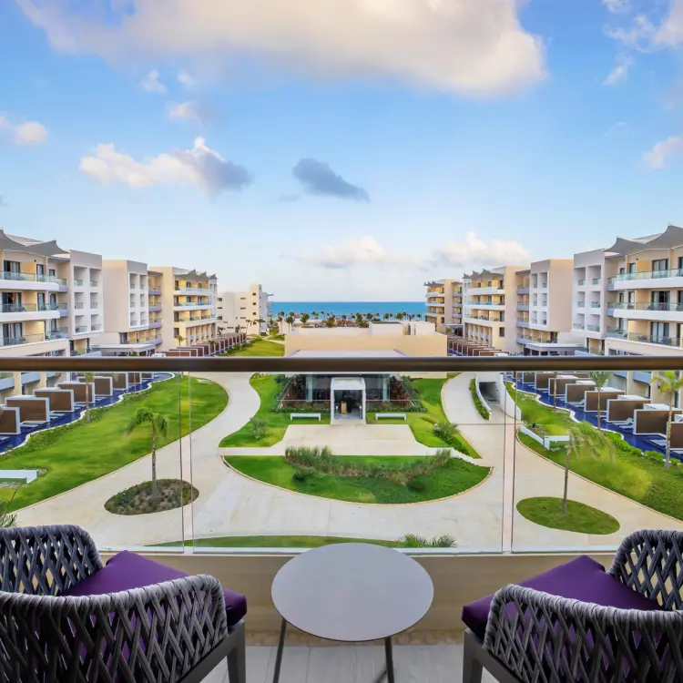 Junior suite balcony view overlooking the grounds and ocean at Planet Hollywood Cancun