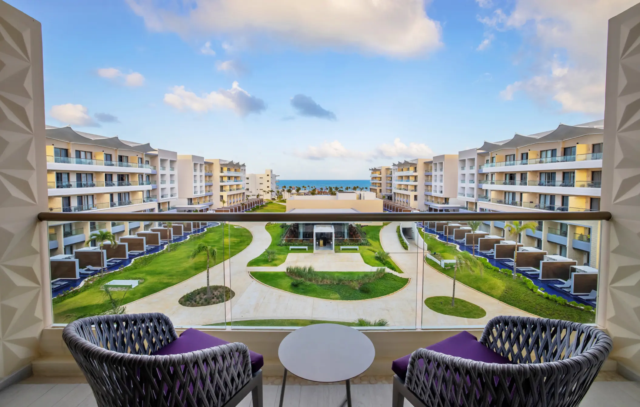 Junior suite balcony view overlooking the grounds and ocean at Planet Hollywood Cancun